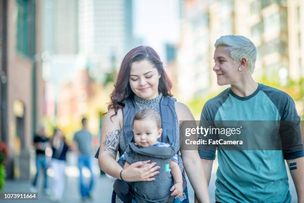 paar wandelen met baby - fat lesbian stockfoto's en -beelden