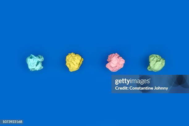 crumpled paper balls arranged in a row - spoil system stock pictures, royalty-free photos & images