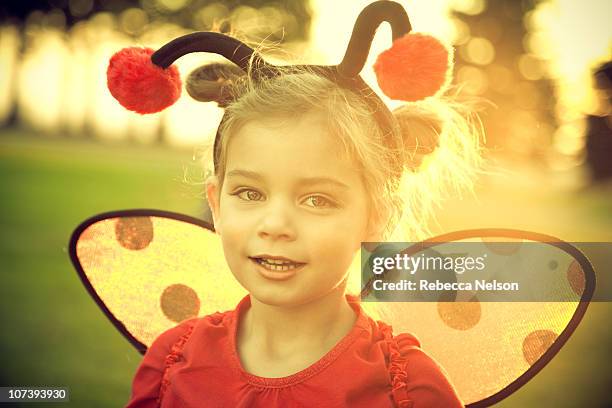 preschool aged girl in lady bug costume at sunset - ladybug costumes for girls stock pictures, royalty-free photos & images