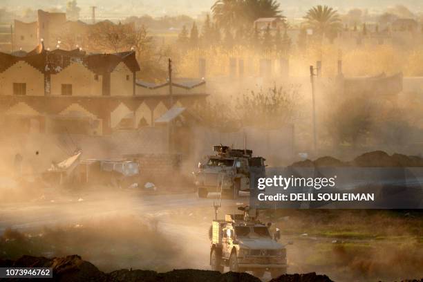 This picture shows US army vehicles supporting the Syrian Democratic Forces in Hajin, in the Deir Ezzor province, eastern Syria, on December 15,...