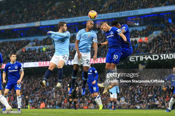 Bernardo Silva of Man City and Fernandinho of Man City compete for a header with Richarlison of Everton during the Premier League match between...