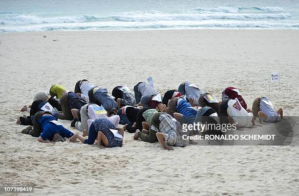 Members of the ONG Sierra Club demonstrate against the countries who according to them are avoiding the climate change issue, in a beach in Cancun on...