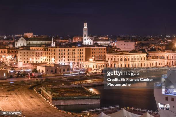 bari skyline illuminated at night in puglia, italy - basilica di san nicola bari - fotografias e filmes do acervo