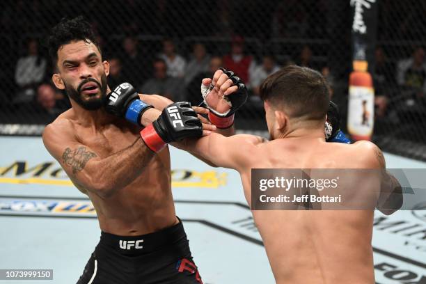 Sergio Pettis punches Rob Font in their bantamweight bout during the UFC Fight Night event at Fiserv Forum on December 15, 2018 in Milwaukee,...