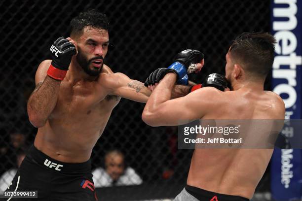 Rob Font punches Sergio Pettis in their bantamweight bout during the UFC Fight Night event at Fiserv Forum on December 15, 2018 in Milwaukee,...