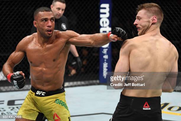 Edson Barboza of Brazil punches Dan Hooker of New Zealand in their lightweight bout during the UFC Fight Night event at Fiserv Forum on December 15,...