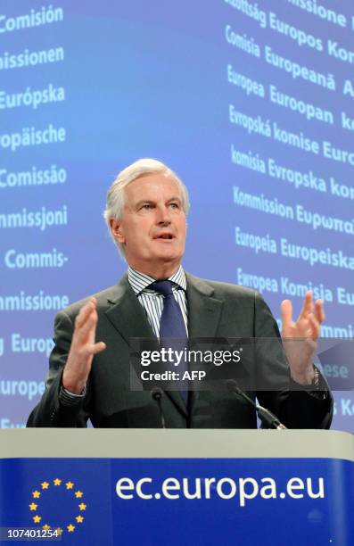 European Union Commissioner for Internal Market and Services Michel Barnier gestures while talking to the media during a press conference at the EU...