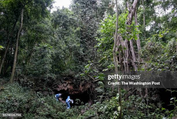 Scientists Brian Amman and Jonathan Towner approach Bat Cave in Queen Elizabeth National Park on August 24, 2018. Amman and Towner placed GPS devices...