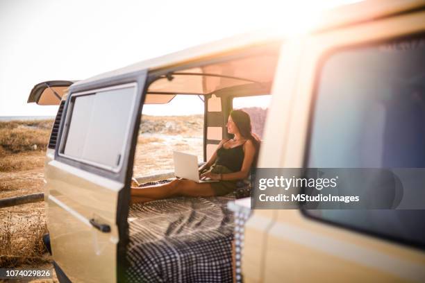 woman using laptop. - travel van stock pictures, royalty-free photos & images