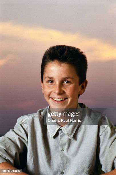 Year old Christian Bale at the Beverly Hilton Hotel during a publicity tour for Empire Of The Sun. He sits on a deck chair beside the swimming pool...