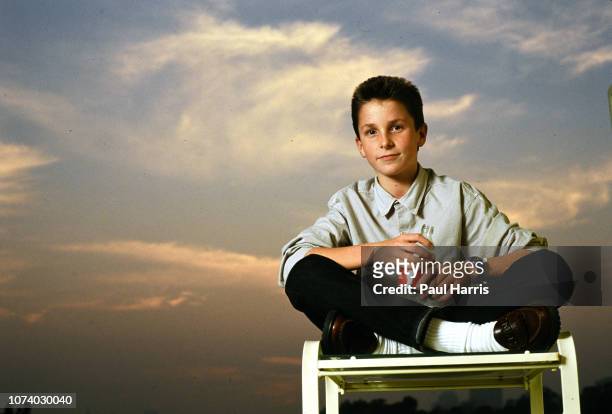 Year old Christian Bale at the Beverly Hilton Hotel during a publicity tour for Empire Of The Sun. He sits on a deck chair beside the swimming pool...