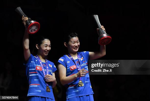 Misaki Matsutomo and Ayaka Takahashi of Japan celebrate on the podium after winning the women's doubles final defeating Lee So Hee and Shin Seung...