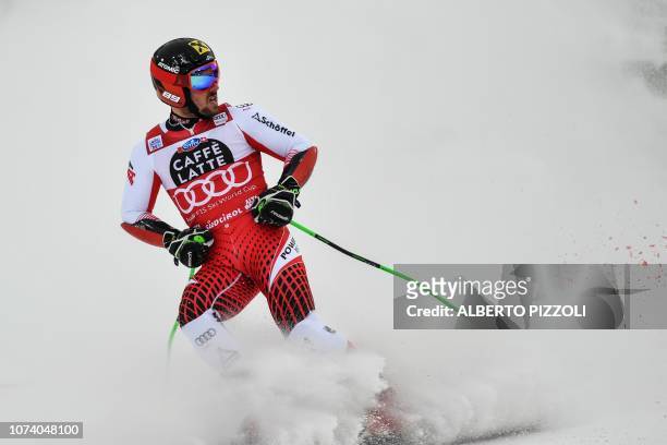 Austria's Marcel Hirscher checks his time after crossing the finish line of the second run of the FIS Alpine World Cup Men Giant Slalom on December...