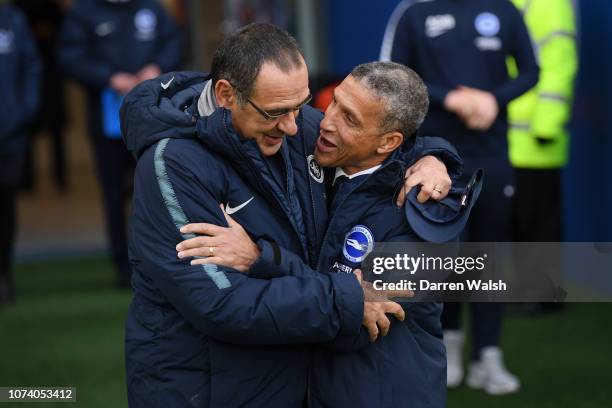 Chris Hughton, Manager of Brighton and Hove Albion and Maurizio Sarri, Manager of Chelsea embrace prior to the Premier League match between Brighton...