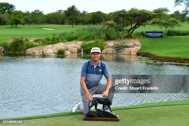 David Lipsky of The United States celebrates with the winners trophy following victory during day four of the Alfred Dunhill Championships at Leopard...
