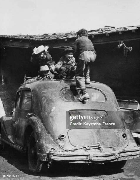 Children Playing On The Roof Of A Car In Paris