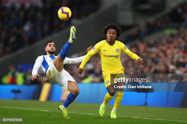 Martin Montoya of Brighton and Hove Albion stretches for the ball under pressure from Willian of Chelsea during the Premier League match between...