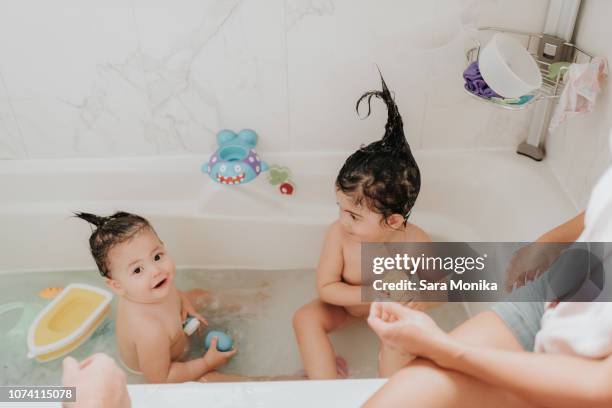 parents with daughter at bath time - baby eltern von oben stock-fotos und bilder