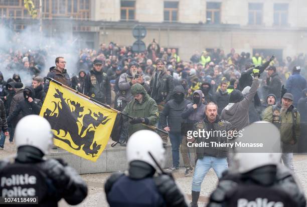 Protesters from the Extreme Right clash with police as they protest against the Marrakech agreement on migration, in the European district area on...