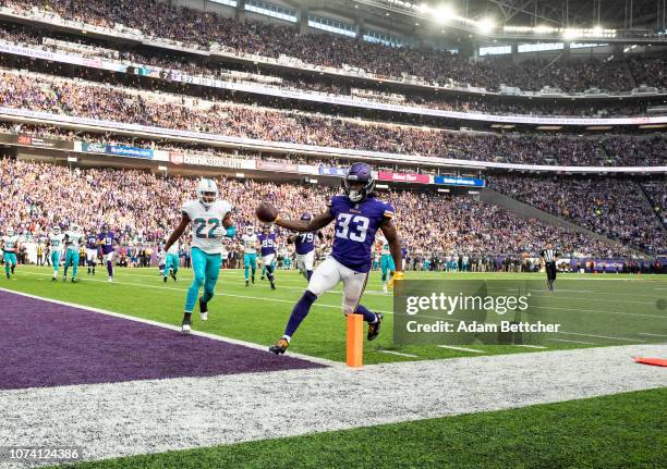 Dalvin Cook of the Minnesota Vikings runs with the ball for a 13 yard touchdown in the first quarter of the game against the Miami Dolphins at U.S....