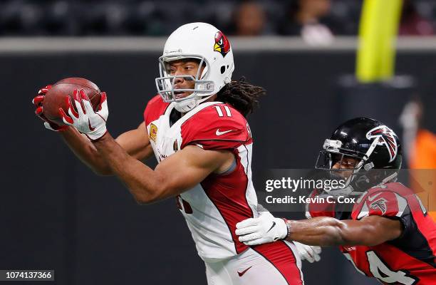 Larry Fitzgerald of the Arizona Cardinals pulls in this reception against Brian Poole of the Atlanta Falcons at Mercedes-Benz Stadium on December 16,...