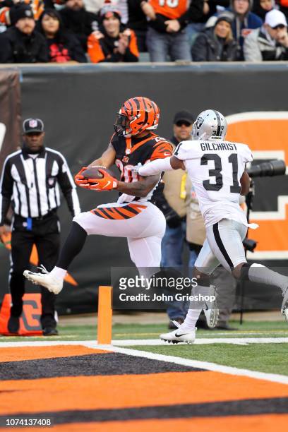Joe Mixon of the Cincinnati Bengals runs past the defense of Marcus Gilchrist of the Oakland Raiders for a touchdown during the fourth quarter at...