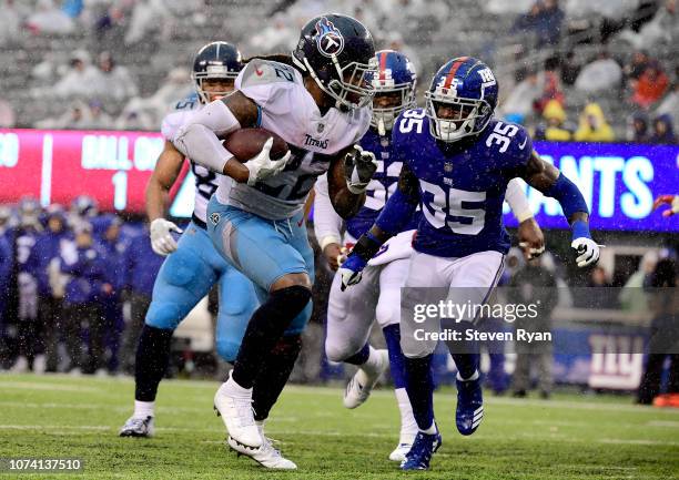 Derrick Henry of the Tennessee Titans gets past Curtis Riley of the New York Giants on his way to a second half touchdown at MetLife Stadium on...