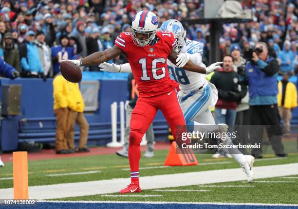 Robert Foster of the Buffalo Bills runs for a touchdown in the fourth quarter during NFL game as Mike Ford of the Detroit Lions attempts to make the...