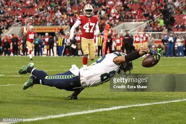 Doug Baldwin of the Seattle Seahawks dives into the end zone for a touchdown against the San Francisco 49ers during their NFL game at Levi's Stadium...