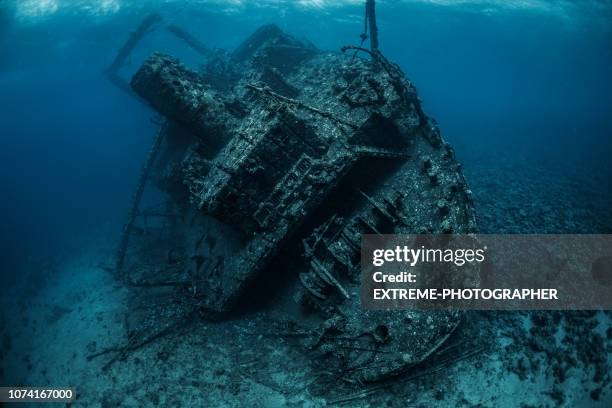 shipwreck rusted and covered with corals and sea life lying on the bottom of the red sea - shipwreck stock pictures, royalty-free photos & images