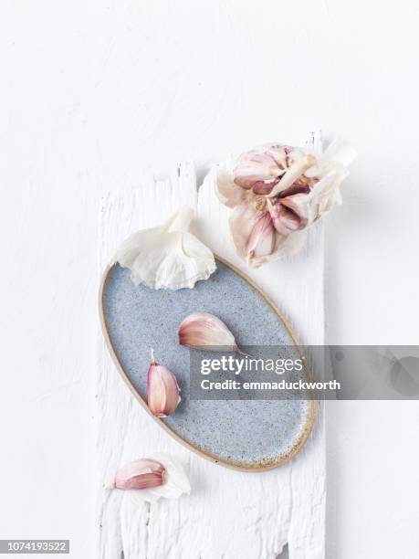 garlic bulb and garlic cloves - food styling stock pictures, royalty-free photos & images
