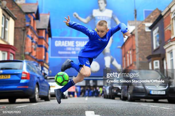 12th August 2017 - Premier League - Everton v Stoke City - A young boy plays football in the streets close to Goodison Park - .