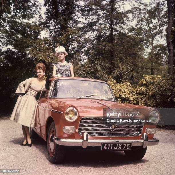 Young Women Presenting The New Peugeot 404 In France On 1960