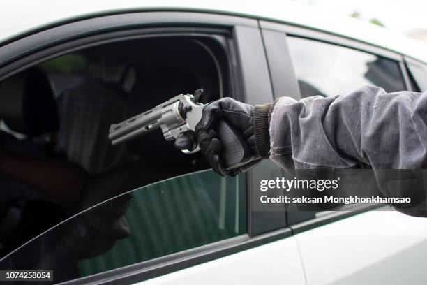 robber thief criminal bandits in robes standing next gun robbed and forced open the car door. to seize the property of the victim.thief concept photo. - stealing imagens e fotografias de stock