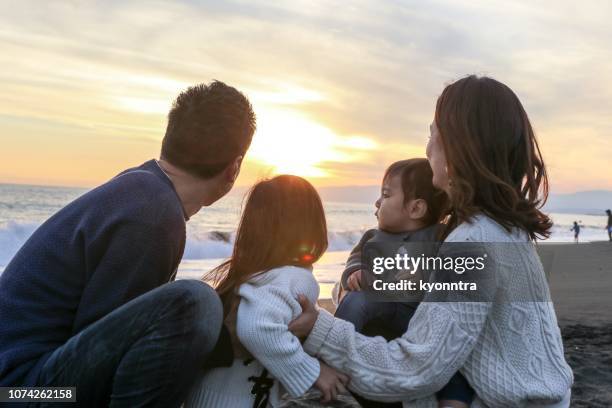 enjoy sunset - japanese couple beach stock pictures, royalty-free photos & images