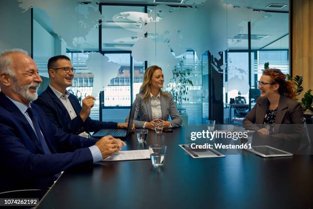 group of happy business people having a meeting - to assemble world stock pictures, royalty-free photos & images