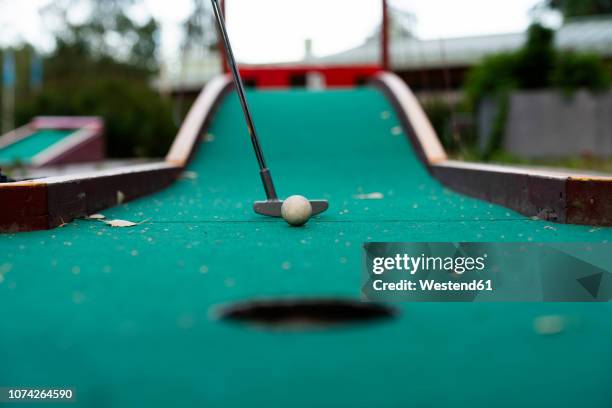 ball and club playing miniature golf - miniature golf stock pictures, royalty-free photos & images