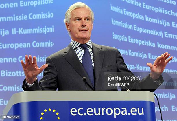 European Union Commissioner for Internal Market and Services Michel Barnier gestures while talking to the media during a press conference at the EU...