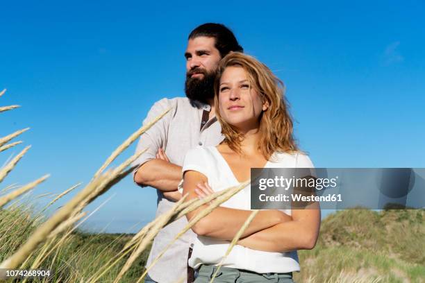 confident couple spending time in nature - couple dunes stock-fotos und bilder