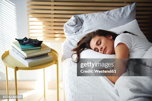Portrait of woman sleeping in bed by daylight Portrait of woman sleeping in bed by daylight