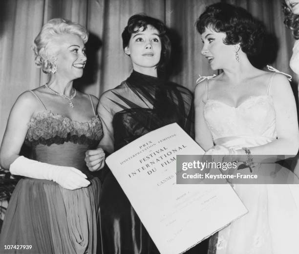 Martine Carol And Gina Lollobrigida Giving The Diploma Of The Gold Palm To Tatiana Samoilova In Cannes In France-Europe On May 20Th 1958