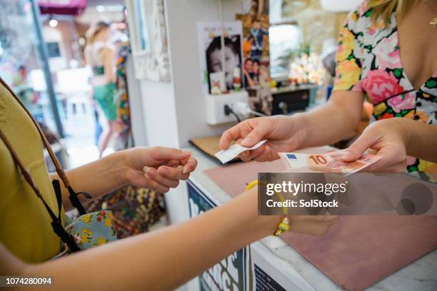 buying souvenirs in italy - european union euro note stock pictures, royalty-free photos & images