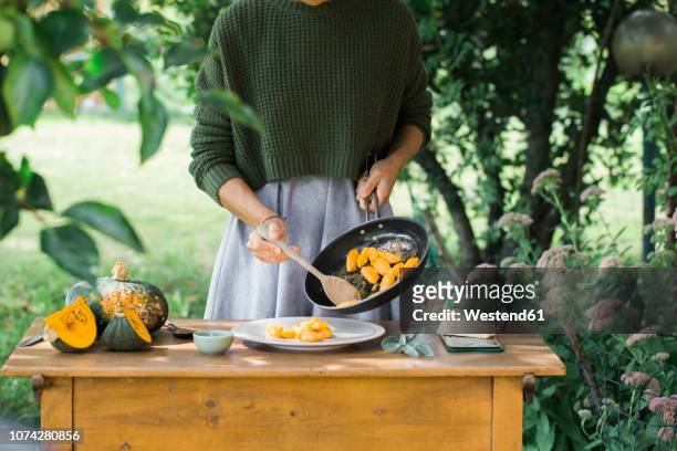 young woman with homemade pumpkin gnocchi, partial view - dieta mediterranea foto e immagini stock