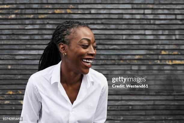 portrait of laughing businesswoman  wearing white shirt - 45 year old woman stock pictures, royalty-free photos & images