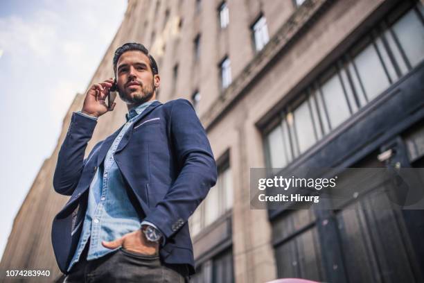 handsome guy talking on phone - white jacket pocket stock pictures, royalty-free photos & images