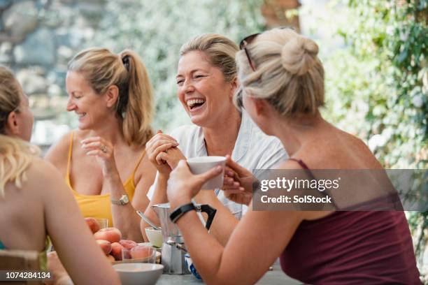 mature women enjoying holiday breakfast - female with friend in coffee stock pictures, royalty-free photos & images