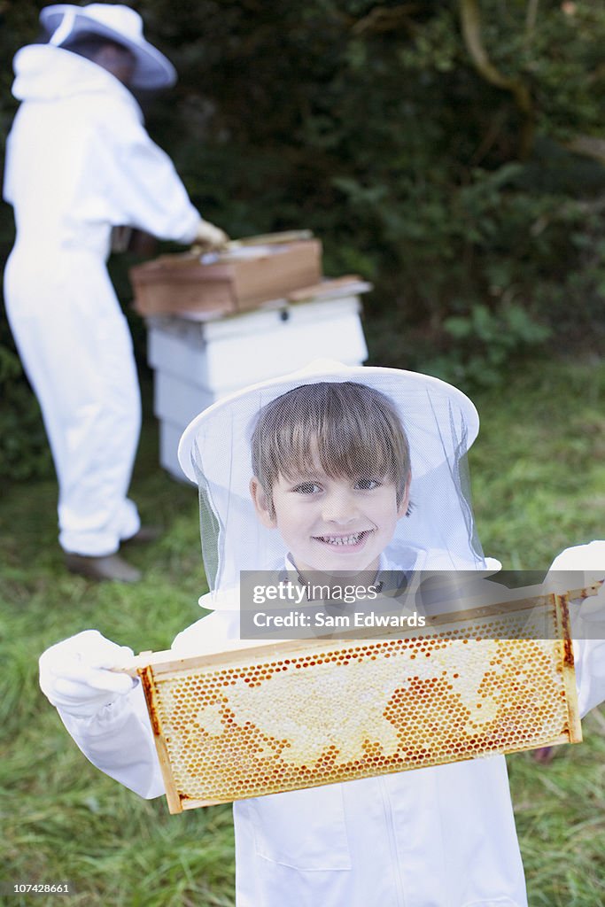 Boy holding bee hive honeycomb