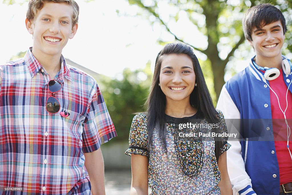 Smiling teenage friends outdoors
