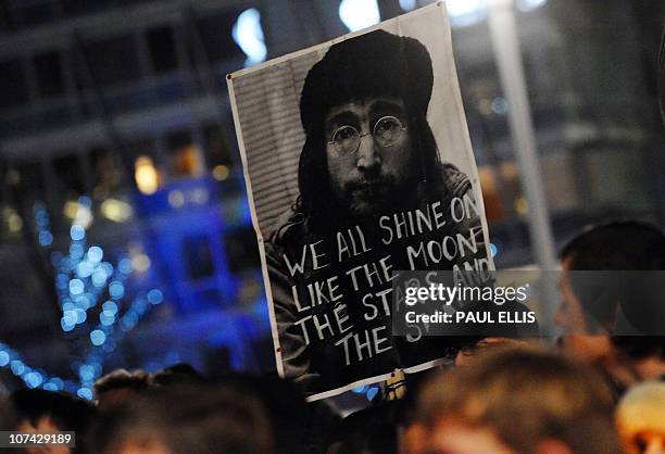 People take part in a candle lit vigil in Liverpool, north-west England on December 8, 2010 to mark the 30th anniversary of the death of former...