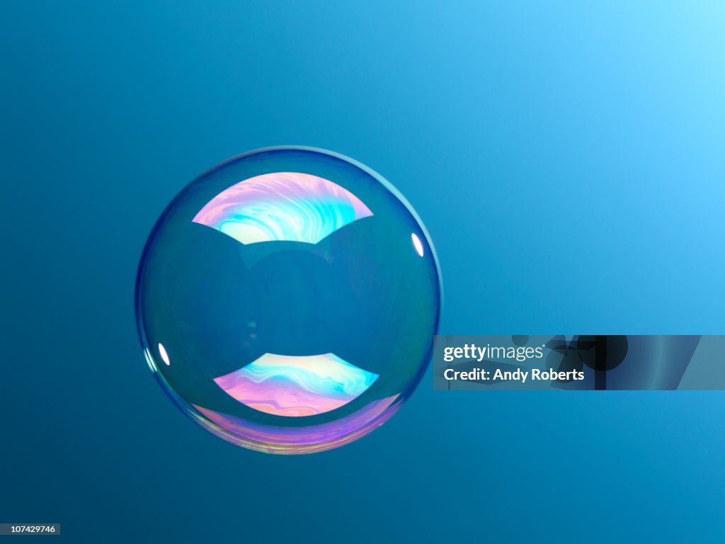 Bubble floating against blue background